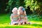 Two kids reading in summer garden