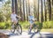 Two kids riding bikes together outdoors on a sunny day