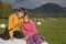 Two kids sitting on a hay bale