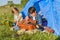 Two kids sitting near tent