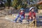 Two kids in sport helmet riding on roller skates at park, spring family activity, outdoors