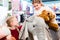 Two kids with stuffed elephant in toy store playing