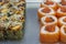 Two kinds of sushi rolls on metal plate. With eel and sesame seeds and red fish and chum salmon caviar.
