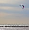 Two kite-boarders windsurfing on a overcast day