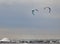 Two kite-boarders windsurfing on a overcast day