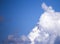 Two kites soar in the clouds in the blue sky