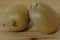 Two kiwi fruit in detail over wood background