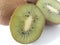 Two Kiwi pieces on a white background with whole kiwifruits