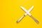 Two knife on yellow background with copy space. Top view. Flat lay. Pattern. Zero waste, save the planet, danger of