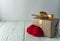 Two knitted hearts, gift box on rustic background