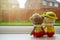 Two knitting dolls girl and boy holding hand sitting next to the window