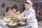 Two Korean chefs cooking traditional meals in Korean food section at tastes of Adana city festival in Turkey country