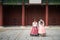 Two Korean women wear hanbok Korea`s tradition dress to visit Gyeongbokgung Palace in Seoul,  South Korea. Tourism, summer holida
