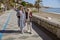 Two ladies on walk through promenade by sea