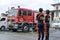 Two lady fire fighters Standing By wedding fire truck