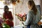 Two lady working a flower wrapping arrangement