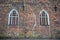 Two lancet windows on ancient brick wall