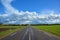 Two-lane asphalt country road, leaving beyond the horizon. Landscape with view of non urban driveway, green ..field, trees and