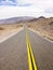 Two Lane Highway Through Desert Landscape