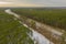 A two-lane road through the forest. View from the drone.