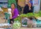 Two Laotian women with baby behind their vegetables which they sell in a mountain village near Luang Prabang