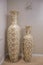 Two large antique beige vases. pitcher standing in the interior of the house