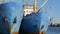 Two large blue old ships. Old fishing port with vintage boats