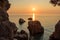 Two large boulders standing in the sea over which the morning sun rises