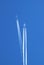 Two large commercial aircrafts in the sky, condensation trails c