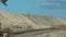 two large dump trucks at a mine