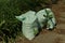 Two large gray garbage bags stand on the pavement