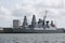 Two large grey warships moored in portsmouth harbour