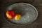 Two large  heirloom heart shaped tomatoes on brass tray, homegrown and  fresh gathered.