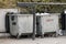 Two large metal dumpsters for paper and waste