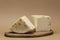 Two large pieces of flavored Italian Caciotta cheese with black peppercorns. Cheese lies on a wooden board. Close-up. Place for