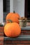 Two large pumpkins on front stoop of home