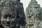 Two large statues in the form of ancestral faces in the ruins of the Bayon temple in Ankgor Thom, Cambodia - UNESCO World Heritage