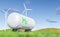 two large wind turbines next to an oil tank with the green h logo on it