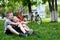 Two laughing boys having fun on the grass. Bicycles in the background