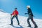 Two laughing to each other young women Rope team ascending Mont blanc du Tacul summit 4248m dressed mountaineering clothes with