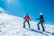 Two laughing to each other young women Rope team ascending Mont blanc du Tacul summit 4248m dressed mountaineering clothes with