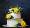 Two layered gilded wedding cake with flowers