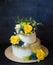 Two layered gilded wedding cake with flowers
