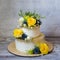 Two layered gilded wedding cake with flowers