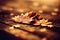 two leaves laying on a wooden surface in the sun light