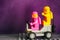 Two Lego astronaut minifigures -  Lenny and Kenny, on Lunar buggy against purple background