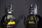 Two Lego Batman minifigures on black background.