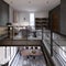 Two-level loft-style interior with a living room and dining area and transitions co glass railing to the library area on the