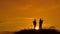 Two lifestyle men tourists hikers silhouette go to the mountains sunset travel slow motion video. Traveler successful