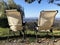 Two light chairs in front of mountains landscape. Europe. Traveling. Hiking